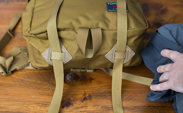 Optional lash straps threaded through the accessory strap holders on the bottom of the Paragon.